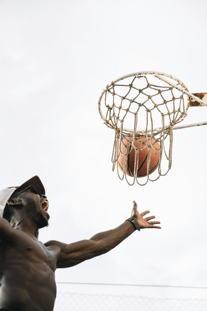 Afro Man Basketball Player In A Street Court