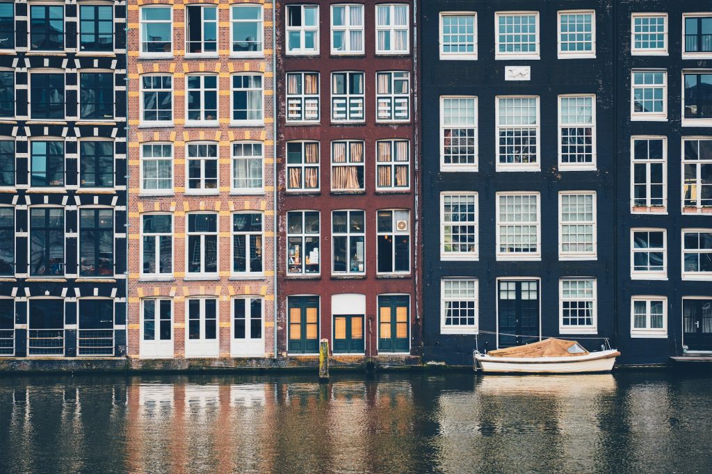 Amsterdam canal Damrak with houses, Netherlands