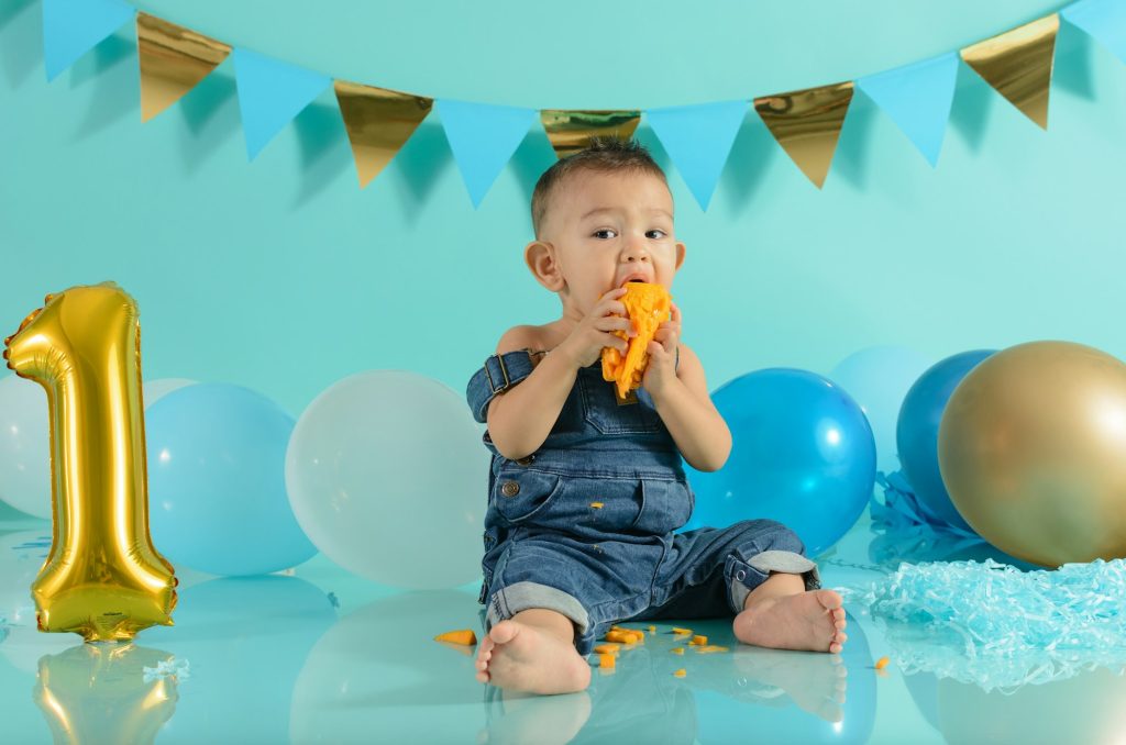 Baby in photo session eating mango.