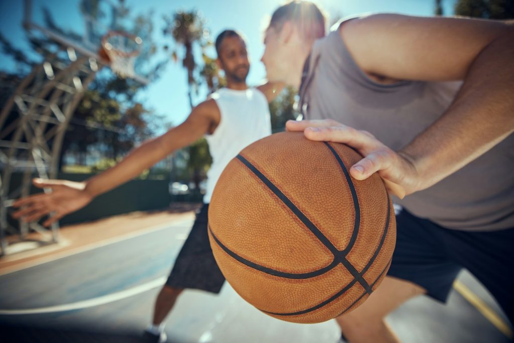 Basketball, competitive sports and practice match with men, players or friends playing a game at an