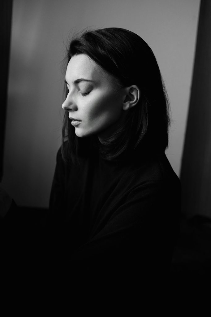 Black and white portrait of young beautiful woman in profile