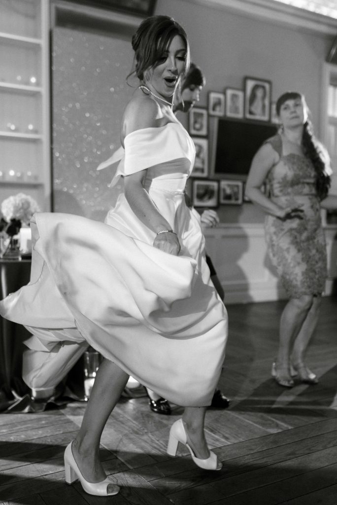 bride in a white dress dances emotionally