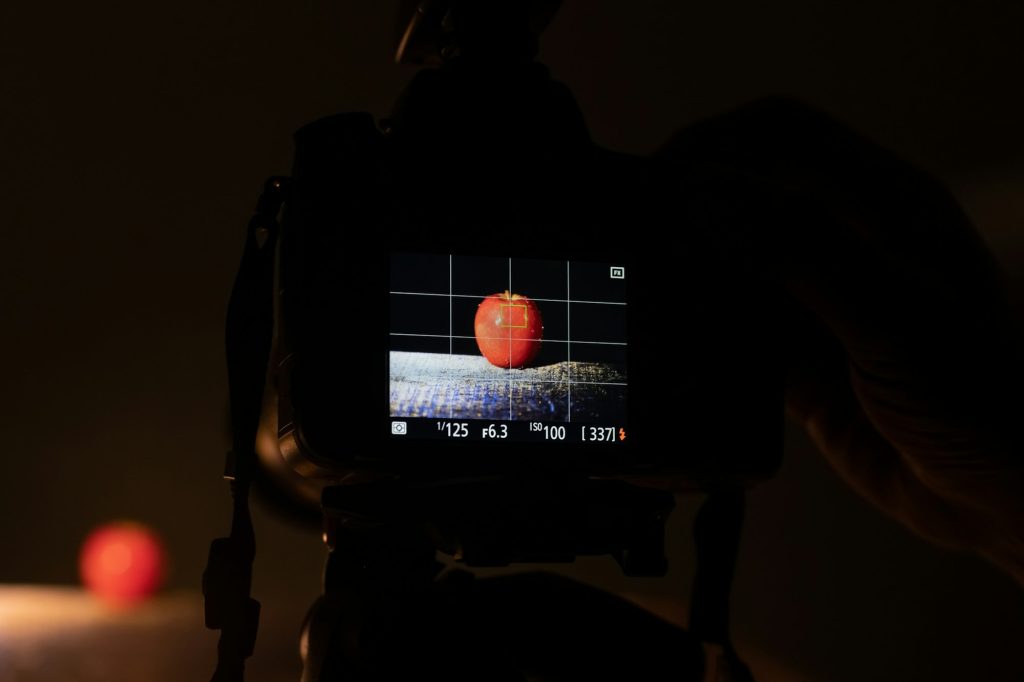 Camera on tripod during food photographing in a dark studio