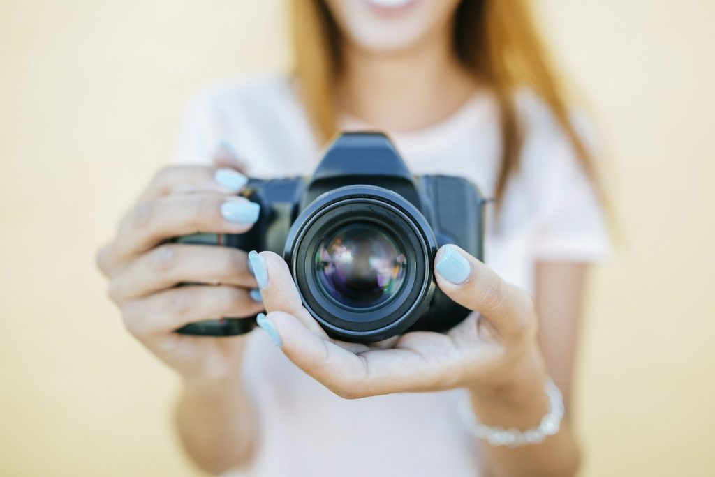 Close-up of woman's hands holding a camara