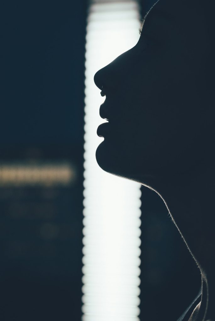 Contra light outline portrait of young woman with septum piercing