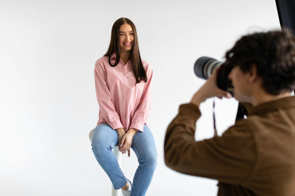 Creating captivating portraits. Photographer taking photos of young european lady, having photoshoot