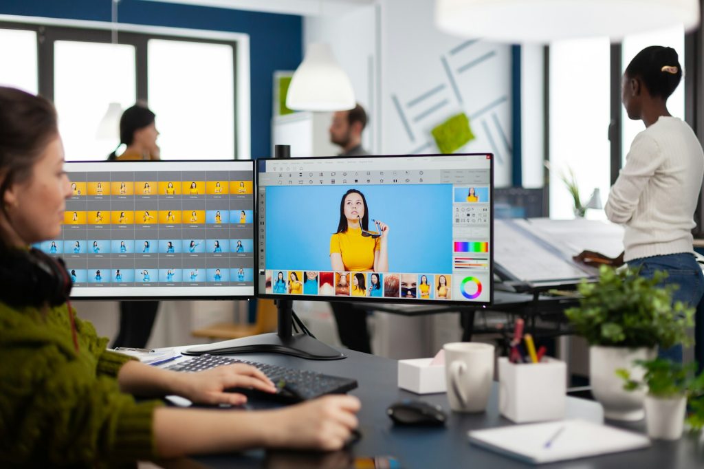 Freelancer retoucher woman working on computer with photo editing software