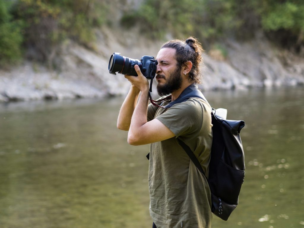 Man photographer in nature. Landscape photographer, traveler, adventurer