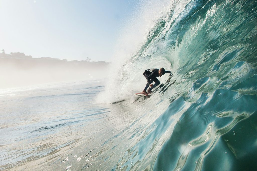 Mid adult man surfing rolling wave, Leucadia, California, USA