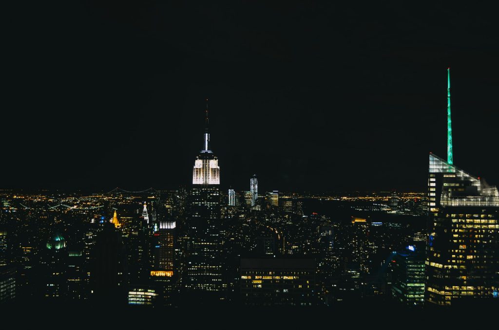 night photo of new york city taken from the top of the rock