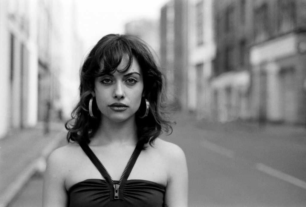 Nostalgic black and white portrait of young woman in a London street.