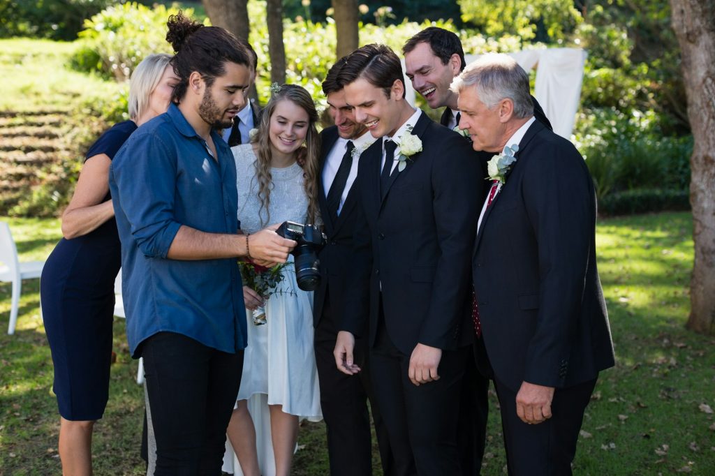 Photographer reviewing photographs on digital camera