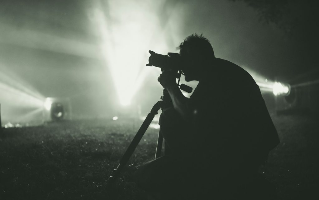 Photographer takes pictures at night in the fog.