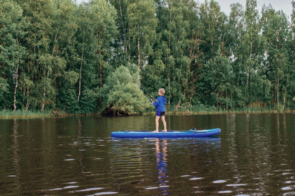 Photography with boy fishing sup. Hobbies, sport , illustrati