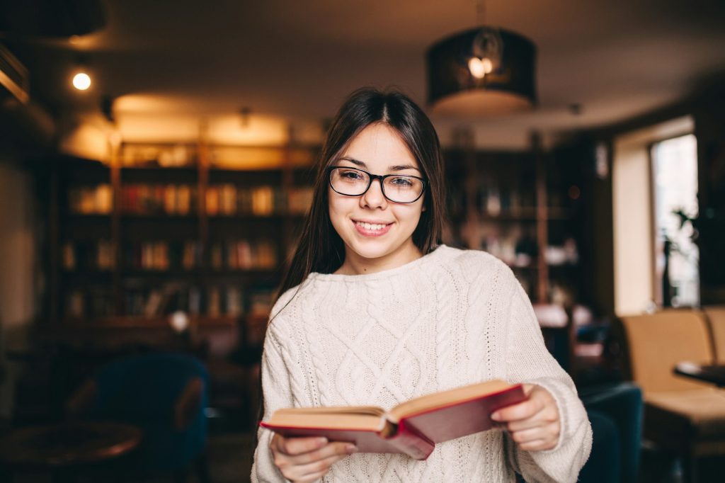 Portrait of a beautiful student in library