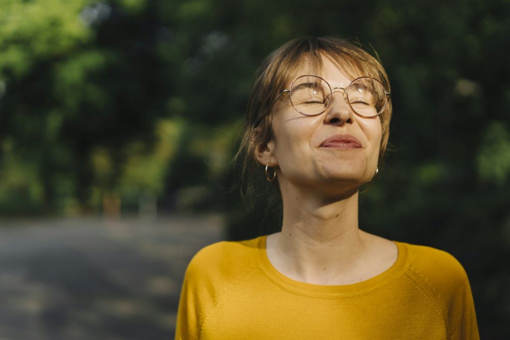 Portrait of content young woman with closed eyes