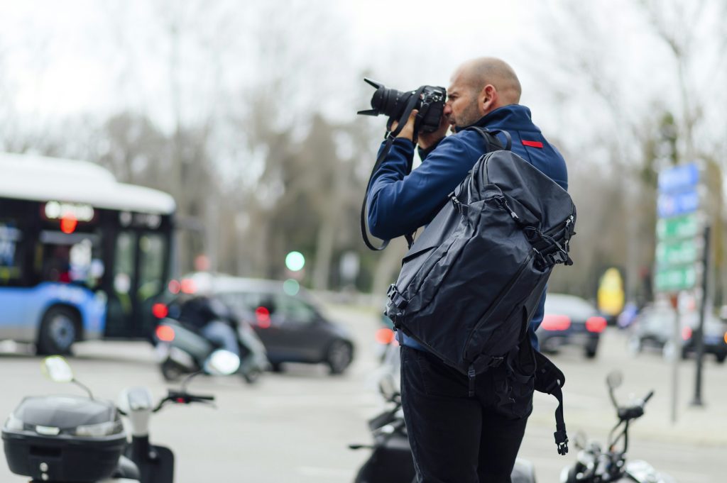 Professional photographer taking a photo in the street