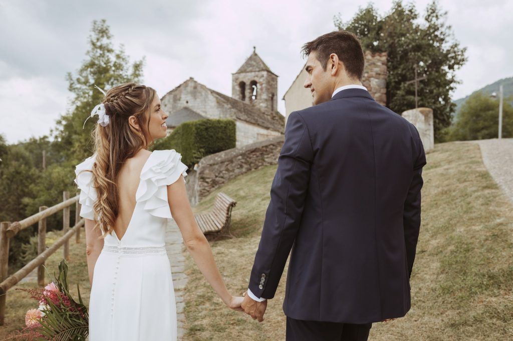 Smiling groom and bride celebrating wedding outdoors