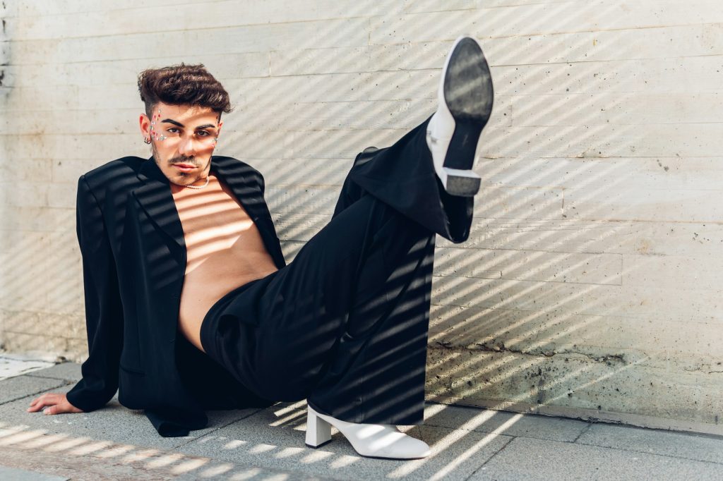 Stylish gay man in trendy clothes on street