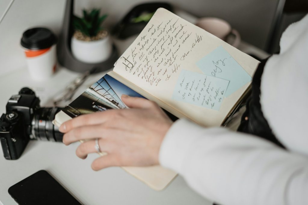 woman holding a notebook, travel/trip planning