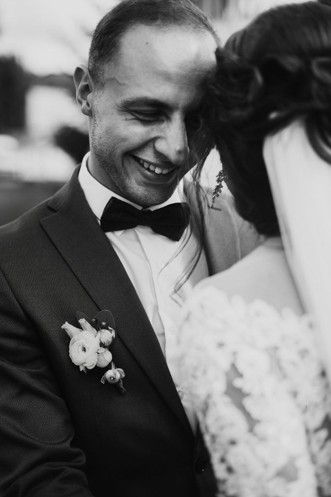 Wedding couple smiling at each other