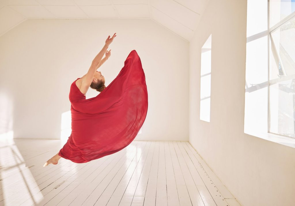 Woman, ballet and dance of a girl student dancing in a red dress in a studio mockup with white wall